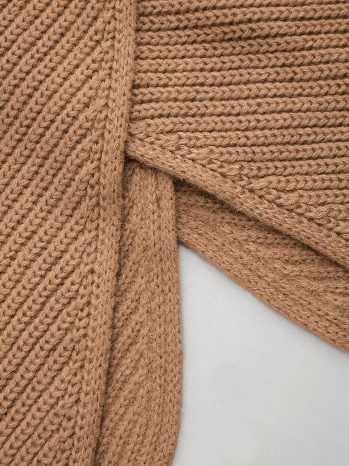 Tan cropped sweater detail, ribbed knit with wrap-twist front at side