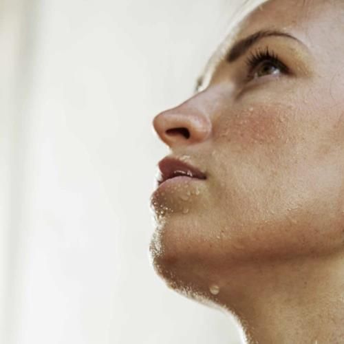 Close-up of underarm with deodorant spray droplets on skin