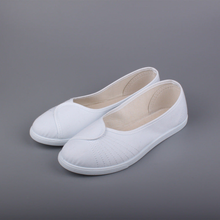 White slip-on casual sneakers with padded heel and textured stitching