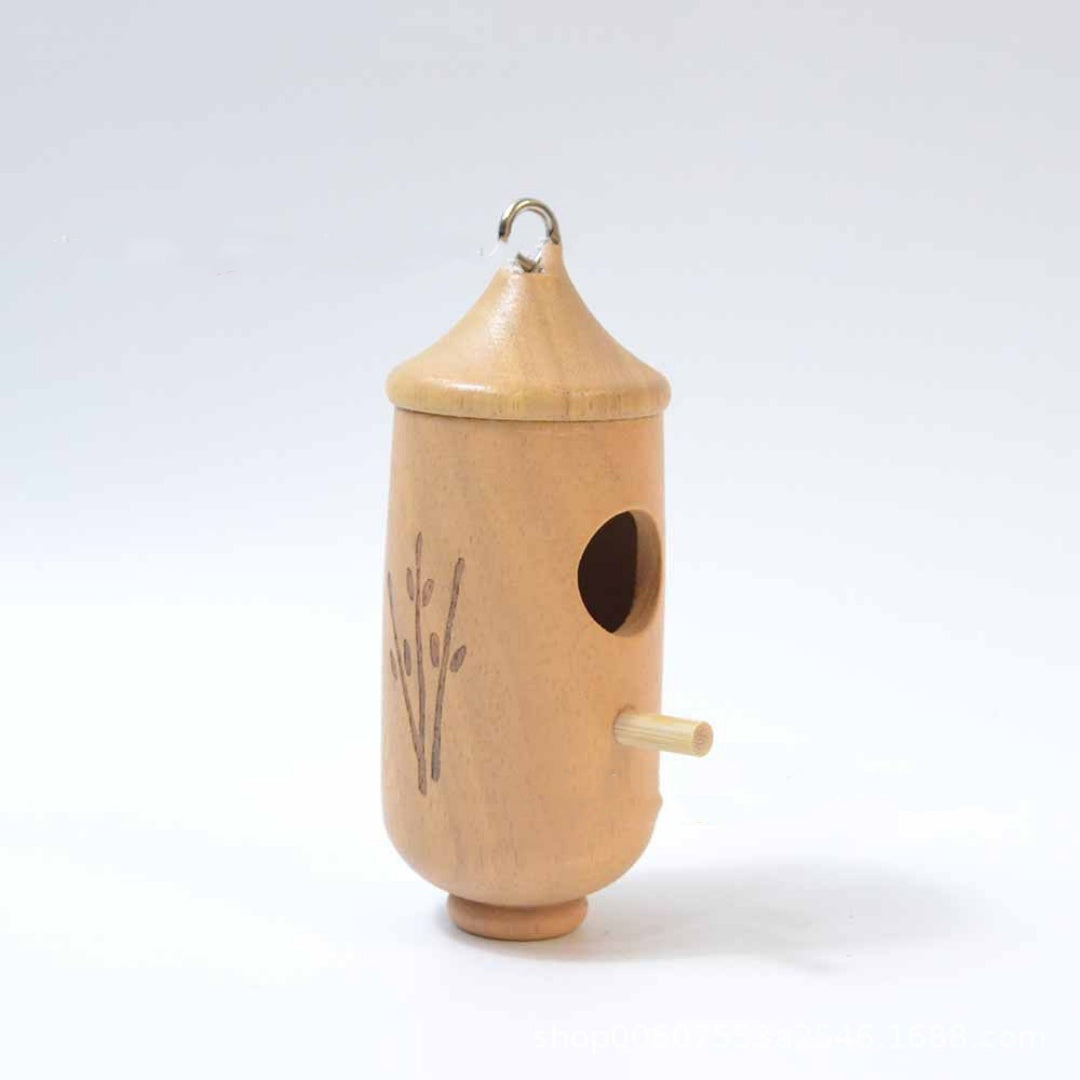 Hanging wooden birdhouse with leaf carving, round entry hole, and horizontal perch stick.
