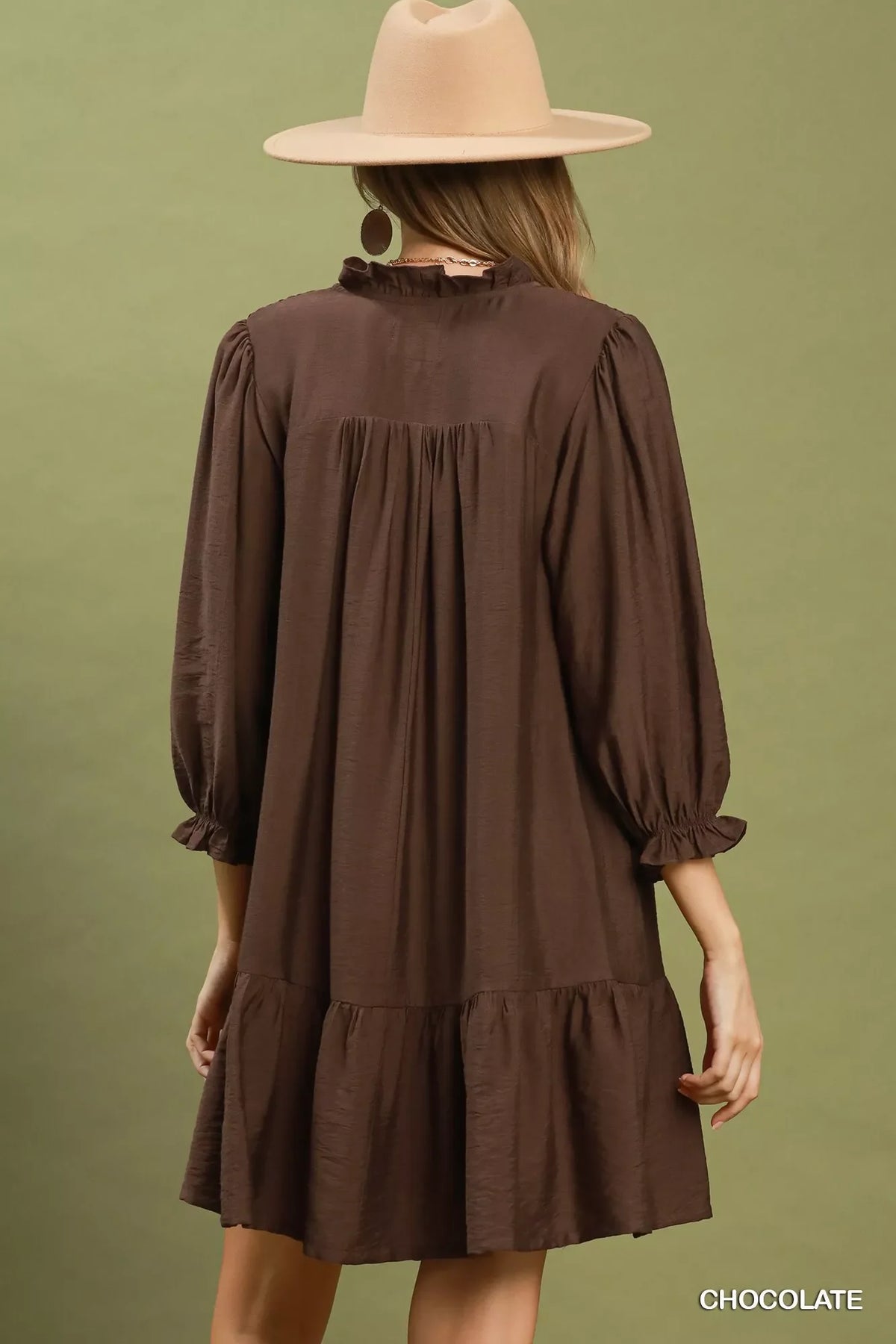 Chocolate-brown tiered mini dress with long sleeves and a gathered back yoke.