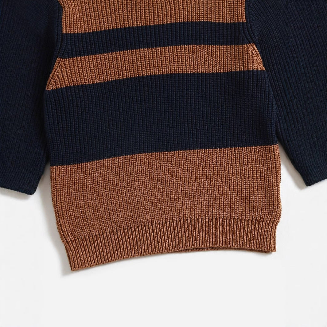 Chunky knit striped sweater close-up: navy and brown horizontal bands, ribbed hem