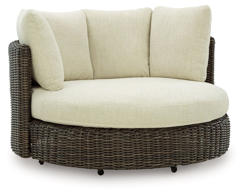 Beige cushioned swivel lounge chair with dark brown woven wicker base
