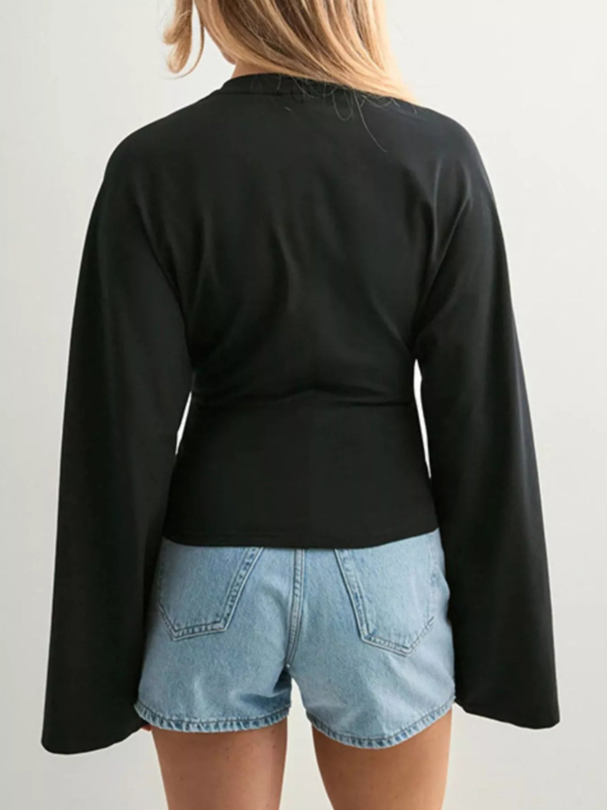 Black long-sleeve fitted t-shirt, back view, crew neck and bell sleeves