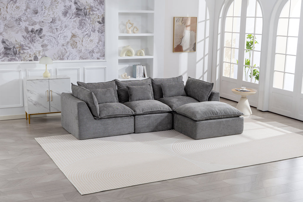 Gray sectional sofa with chaise ottoman and back cushions in a modular configuration
