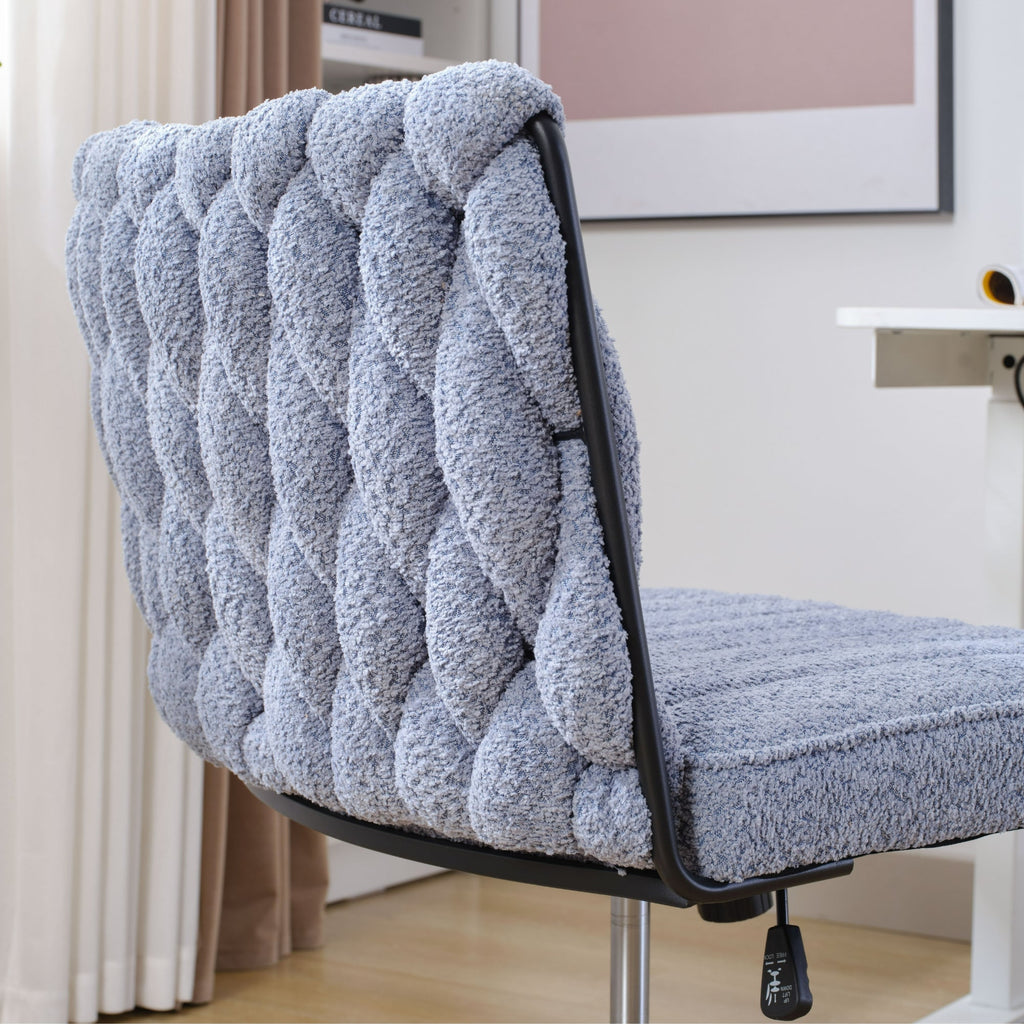 Blue armless office chair with tufted backrest and seat cushion on black pedestal base.