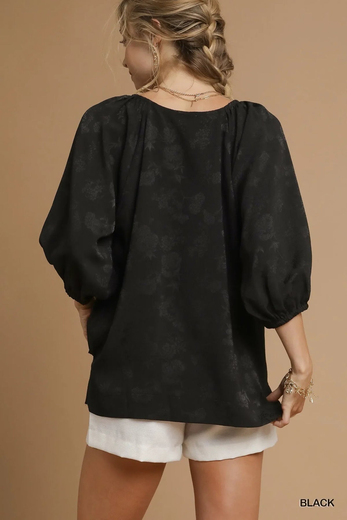 Black jacquard blouse back view with puff sleeves and gathered shoulders