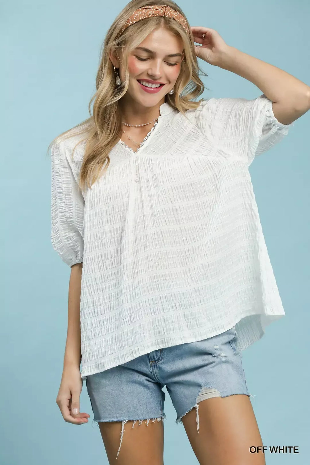 Off-white textured puff-sleeve blouse with scalloped V-neck lace trim