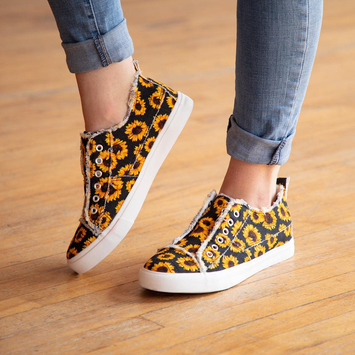 Sunflower print slip-on canvas sneakers with white sole and eyelet trim