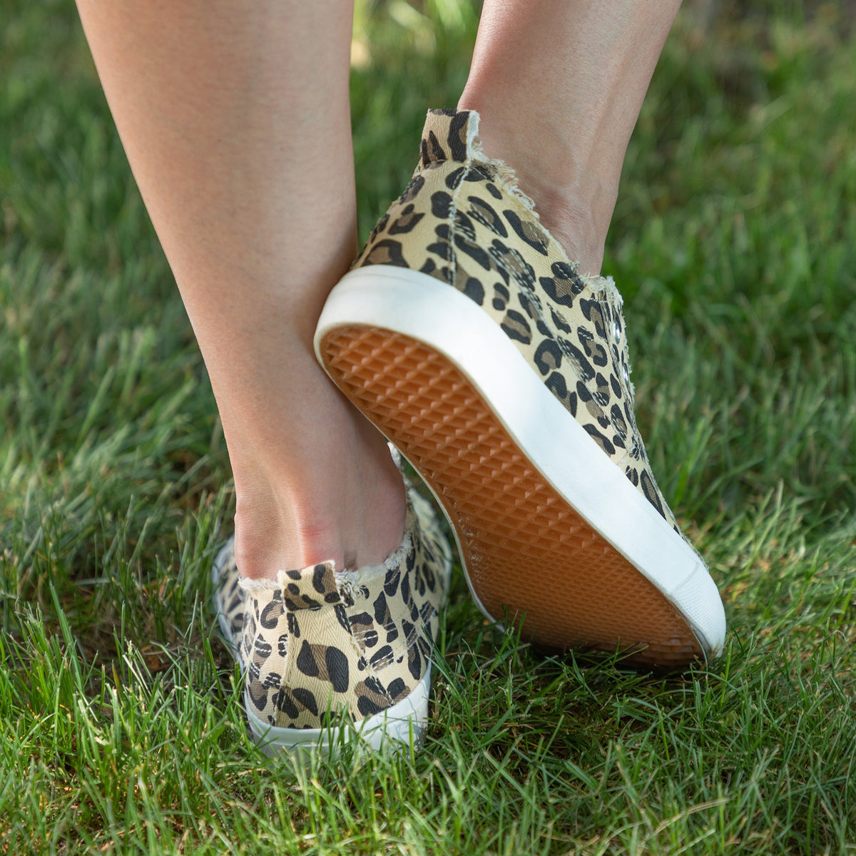 Leopard print slip-on canvas sneaker showing side and white sole