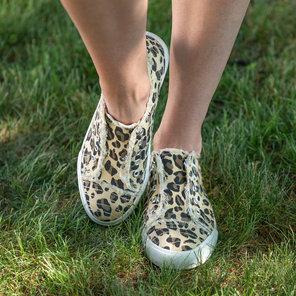 Leopard print slip-on canvas sneakers with white sole and grommet eyelets
