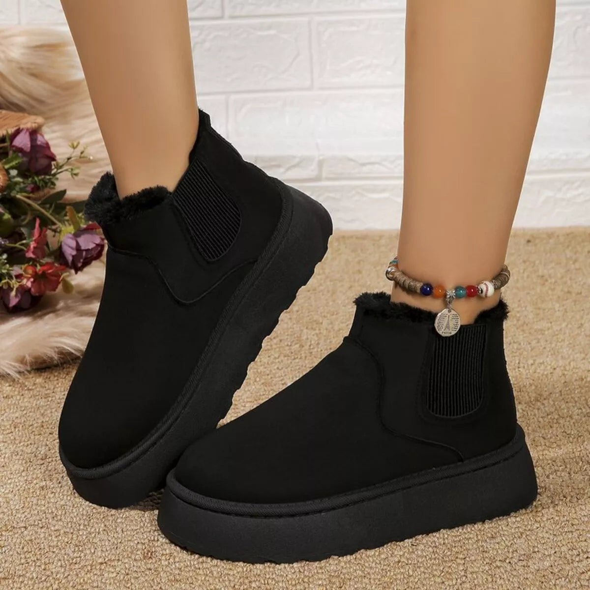 Black platform ankle boots with round toe, elastic gore, and faux fur trim
