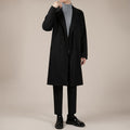 Black mid-length wool trench coat with notched lapels and double-breasted button closure