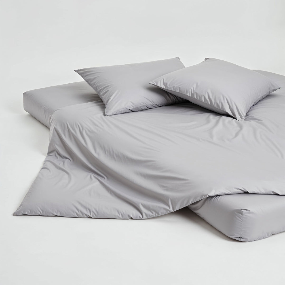 Gray pillowcase set with two folded pillowcases stacked on a light surface