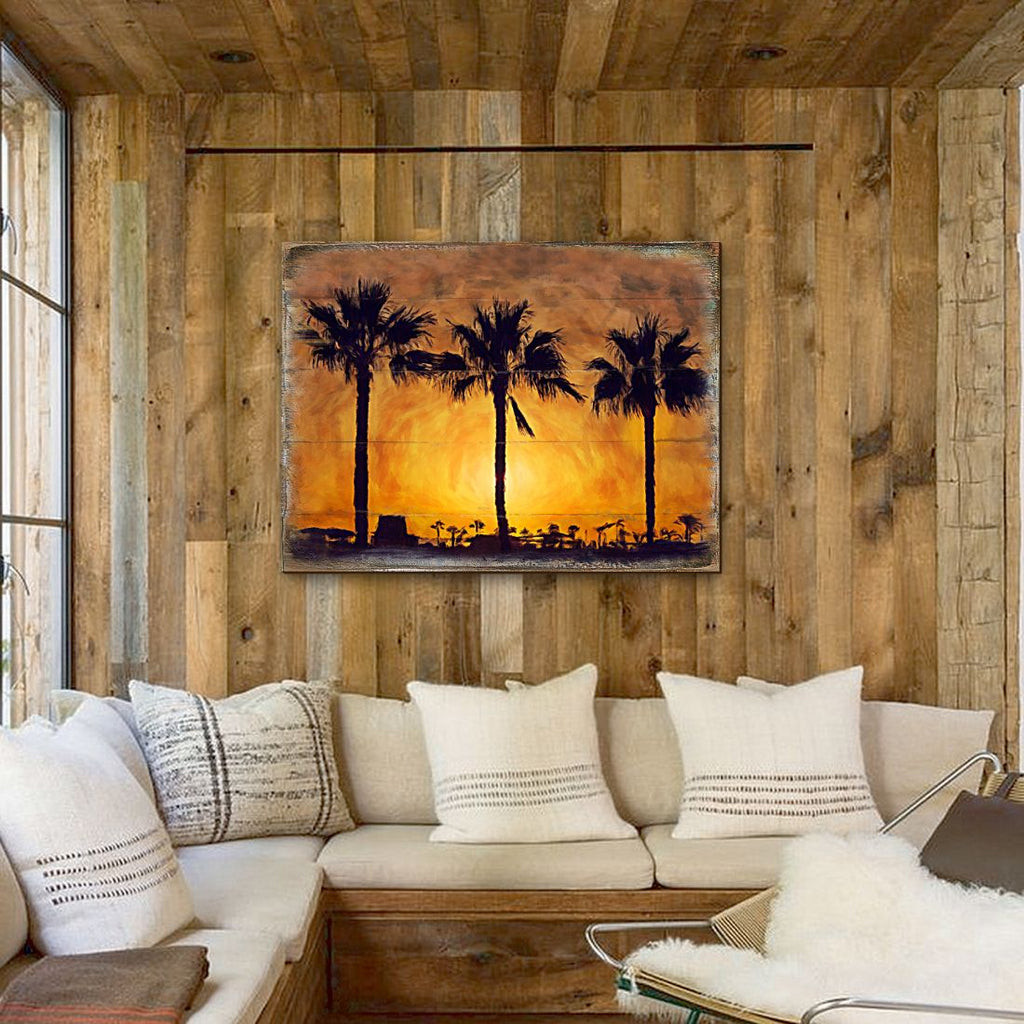 Palm tree sunset wooden wall art on rustic wall, silhouetted palms in orange sky