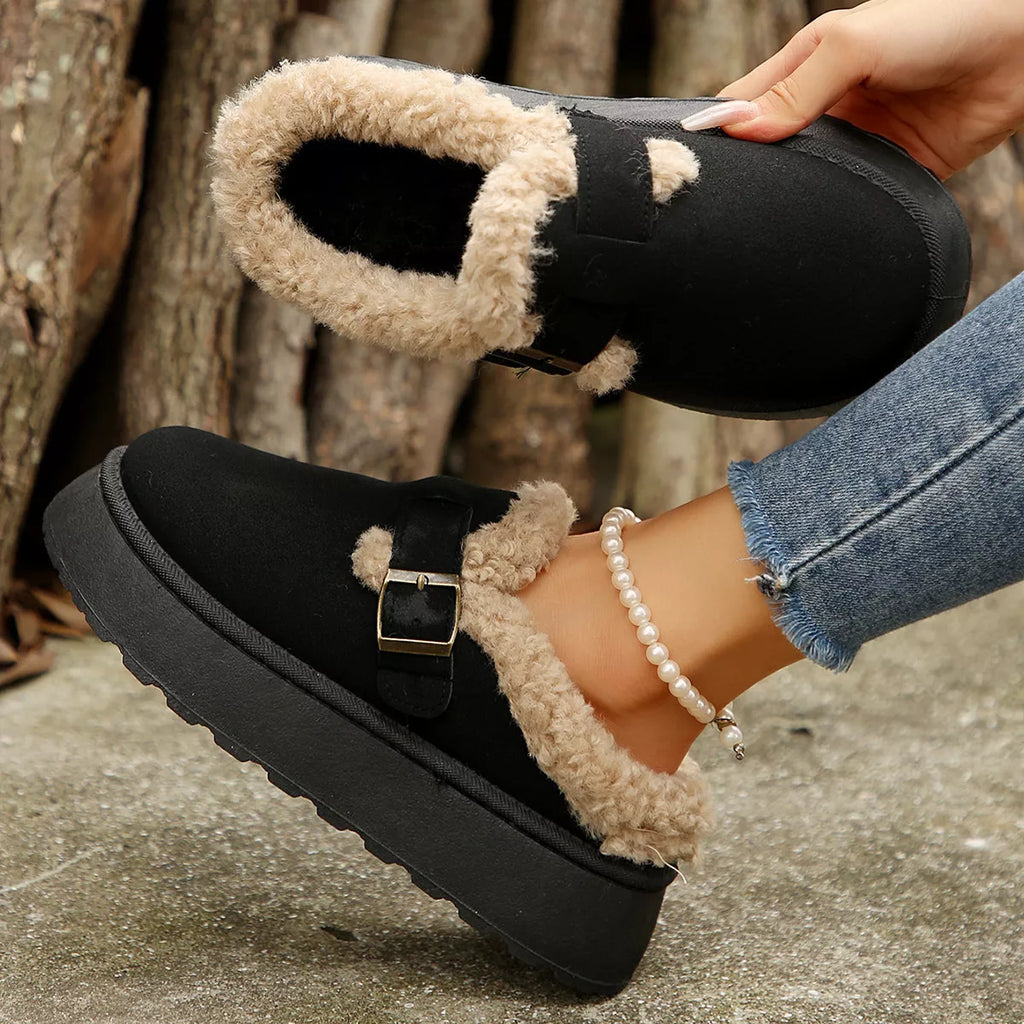 Black platform slippers with fuzzy trim and gold-tone buckle strap