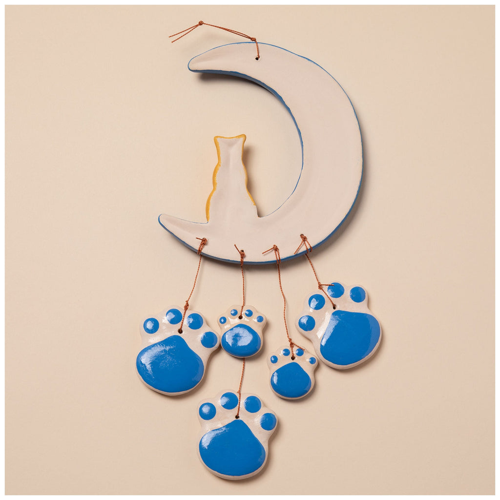 Ceramic cat wind chime with blue crescent moon, gold cat figurine, and hanging paw charms