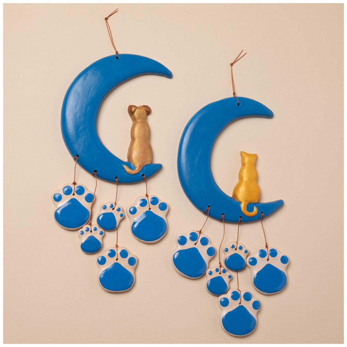 Ceramic wind chime pair with blue crescent moons, gold cat figurines, and blue paw charms