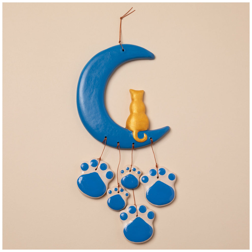 Ceramic wind chime featuring a blue crescent moon, gold cat figurine, and blue paw cluster