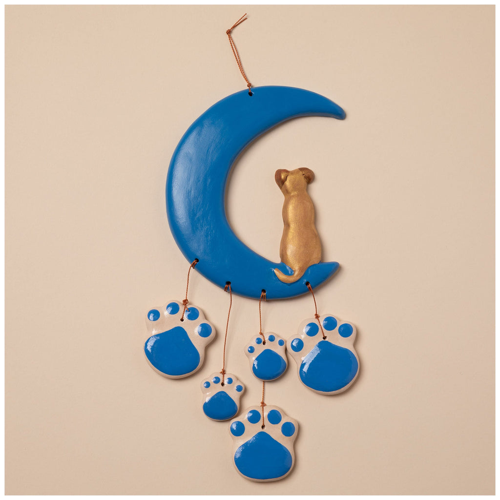 Ceramic wind chime with blue crescent moon, gold cat figure, and blue paw charm cluster