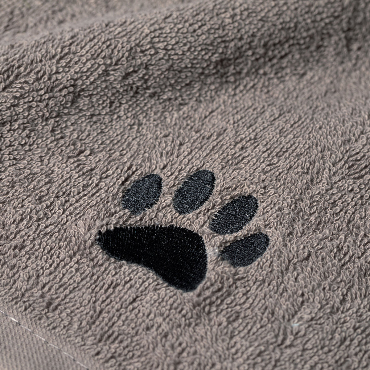 Embroidered paw wash cloth detail, gray terry fabric with black paw print