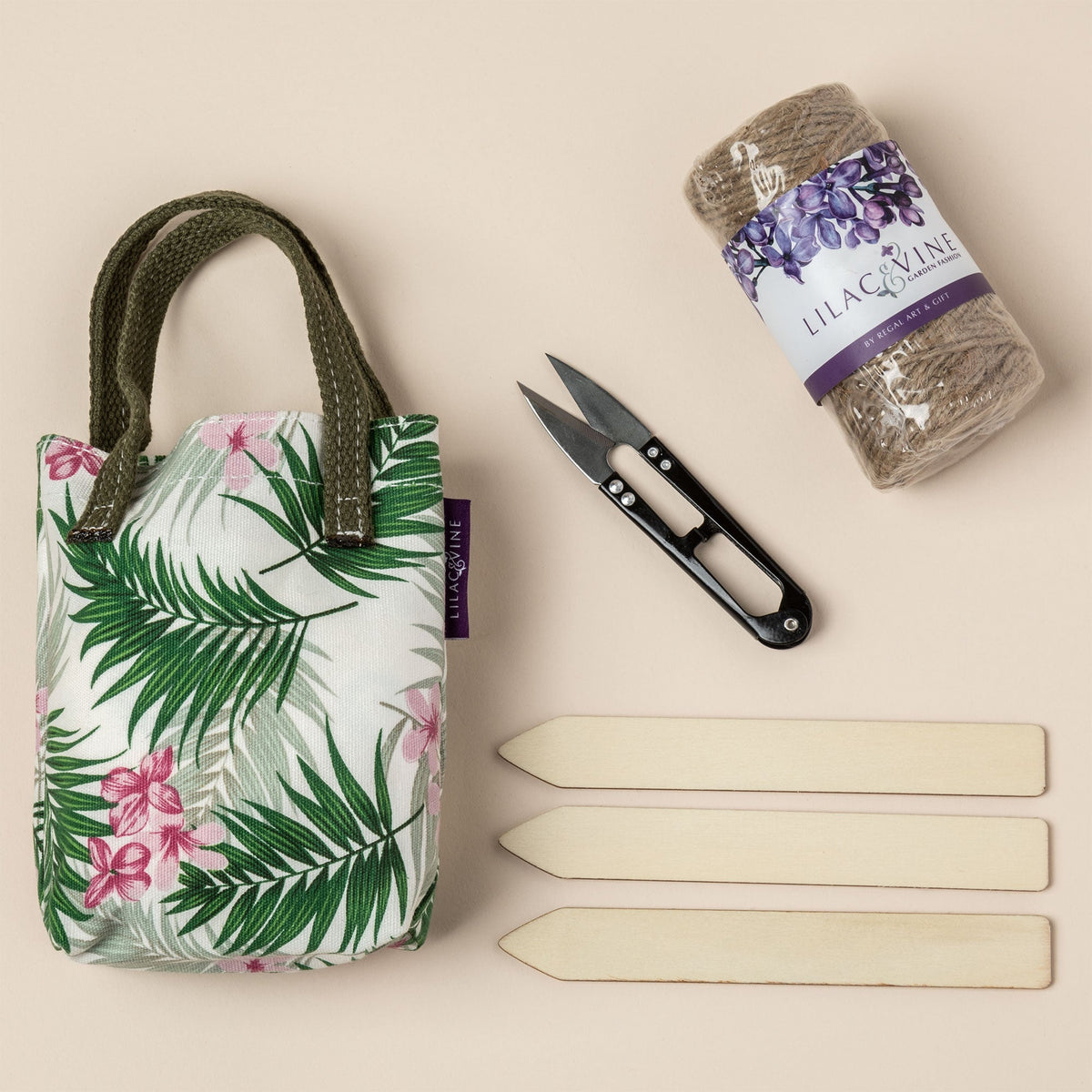 Tropical floral tote bag with green handles, black scissors, purple seed packet