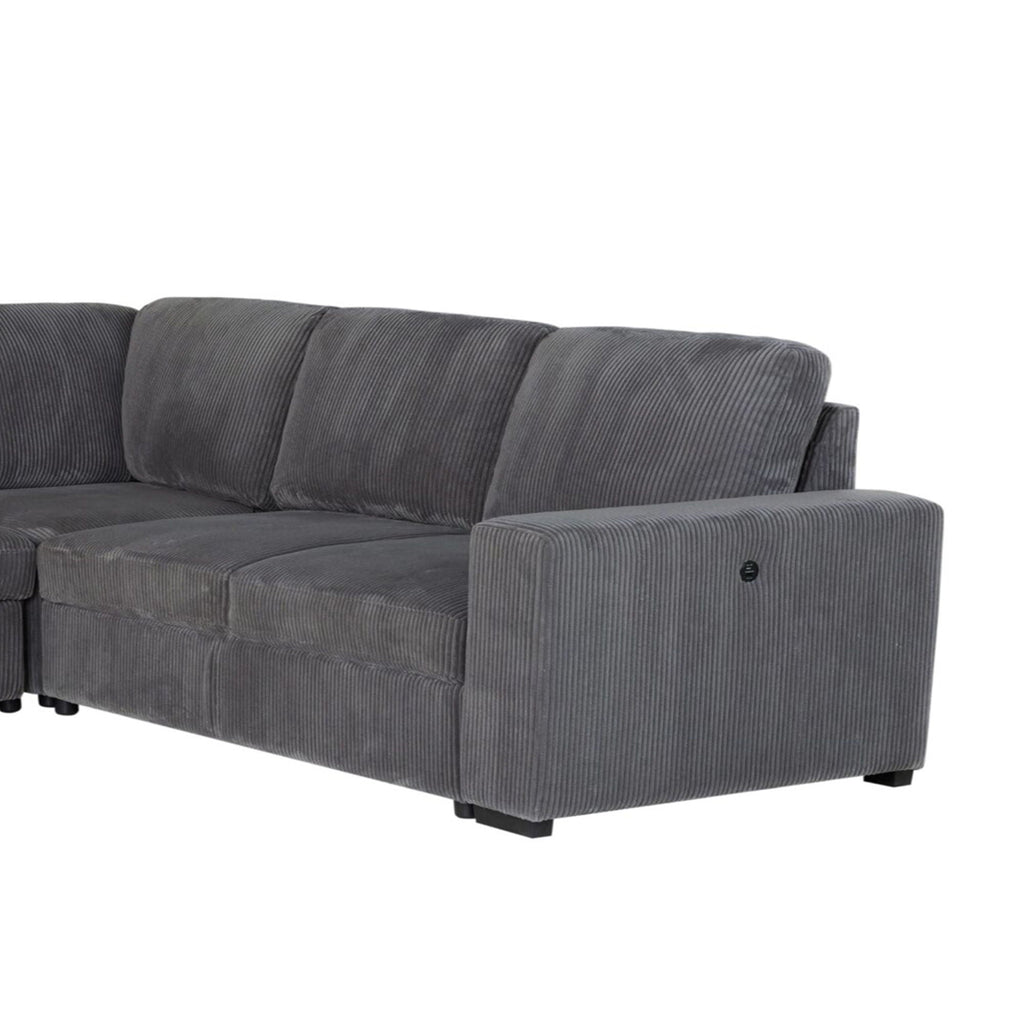 Dark gray sectional sofa with textured fabric, tufted cushions, and cushioned armrest