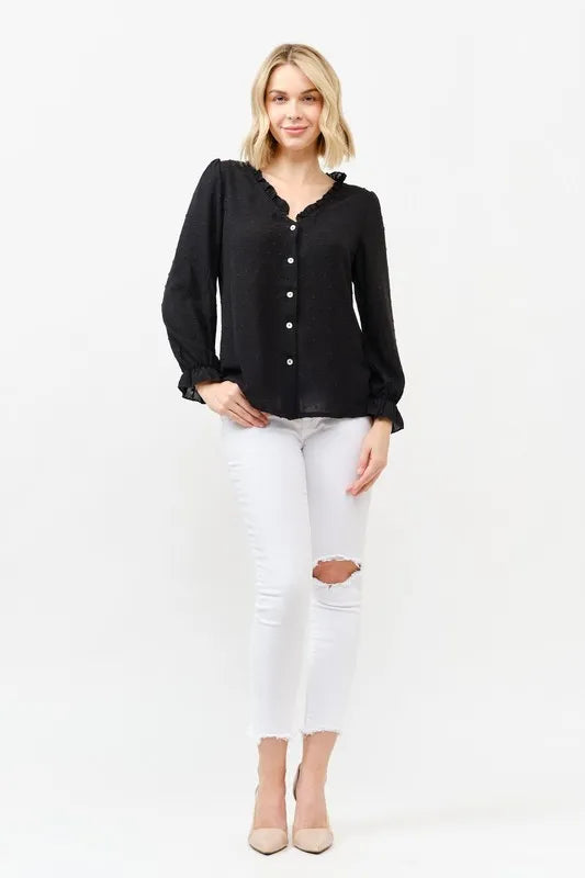 Black polka-dot blouse with ruffle neckline, button front, and long sleeves