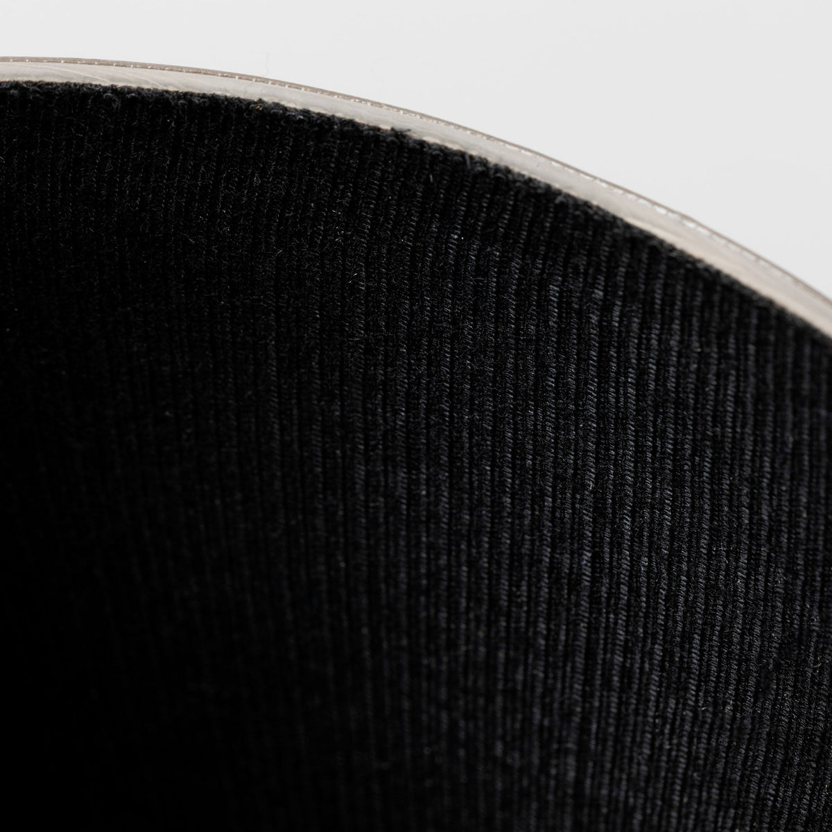 Black boot shaft with ribbed fabric cuff and top edge trim.