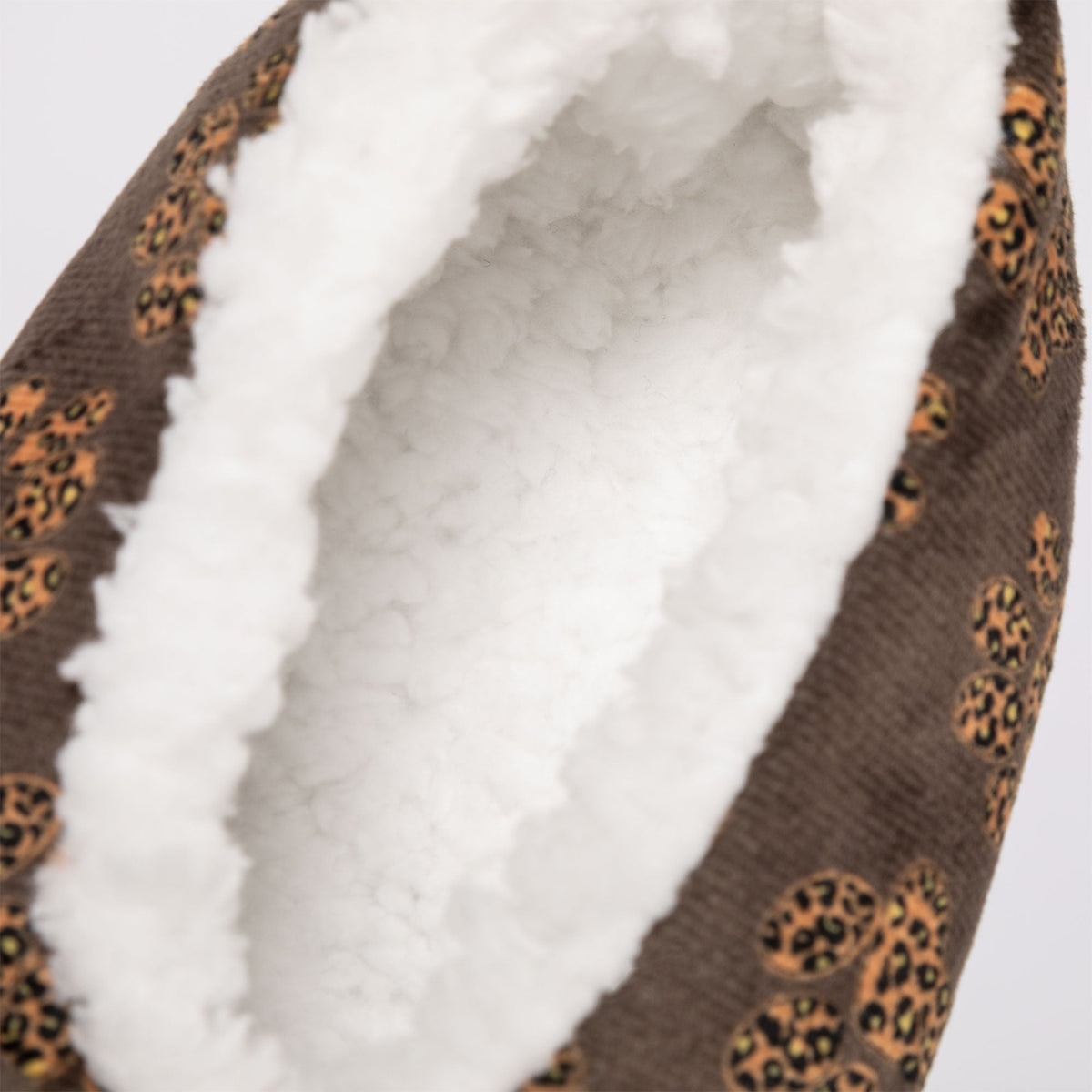 Close-up of leopard paw slipper interior with plush white lining and brown fabric