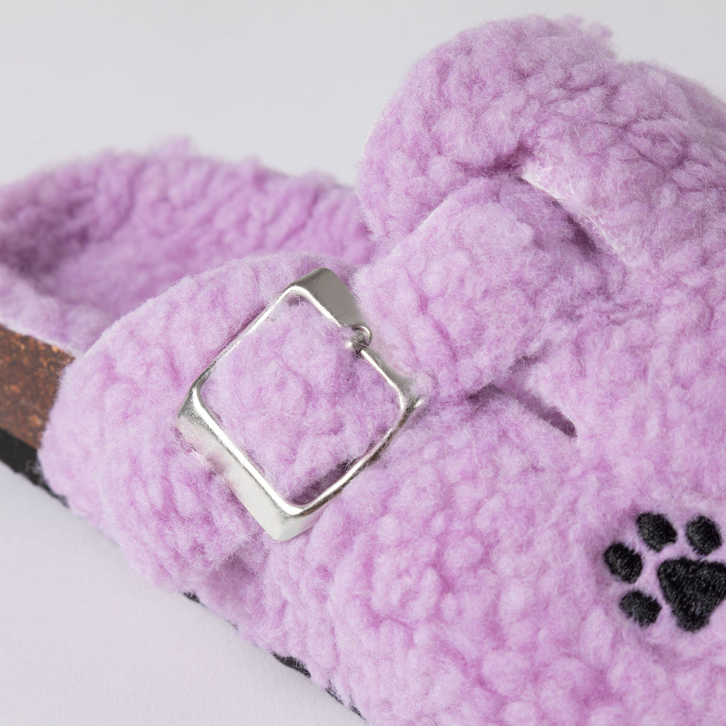Purple plush sherpa clog slipper close-up with silver buckle and paw print detail