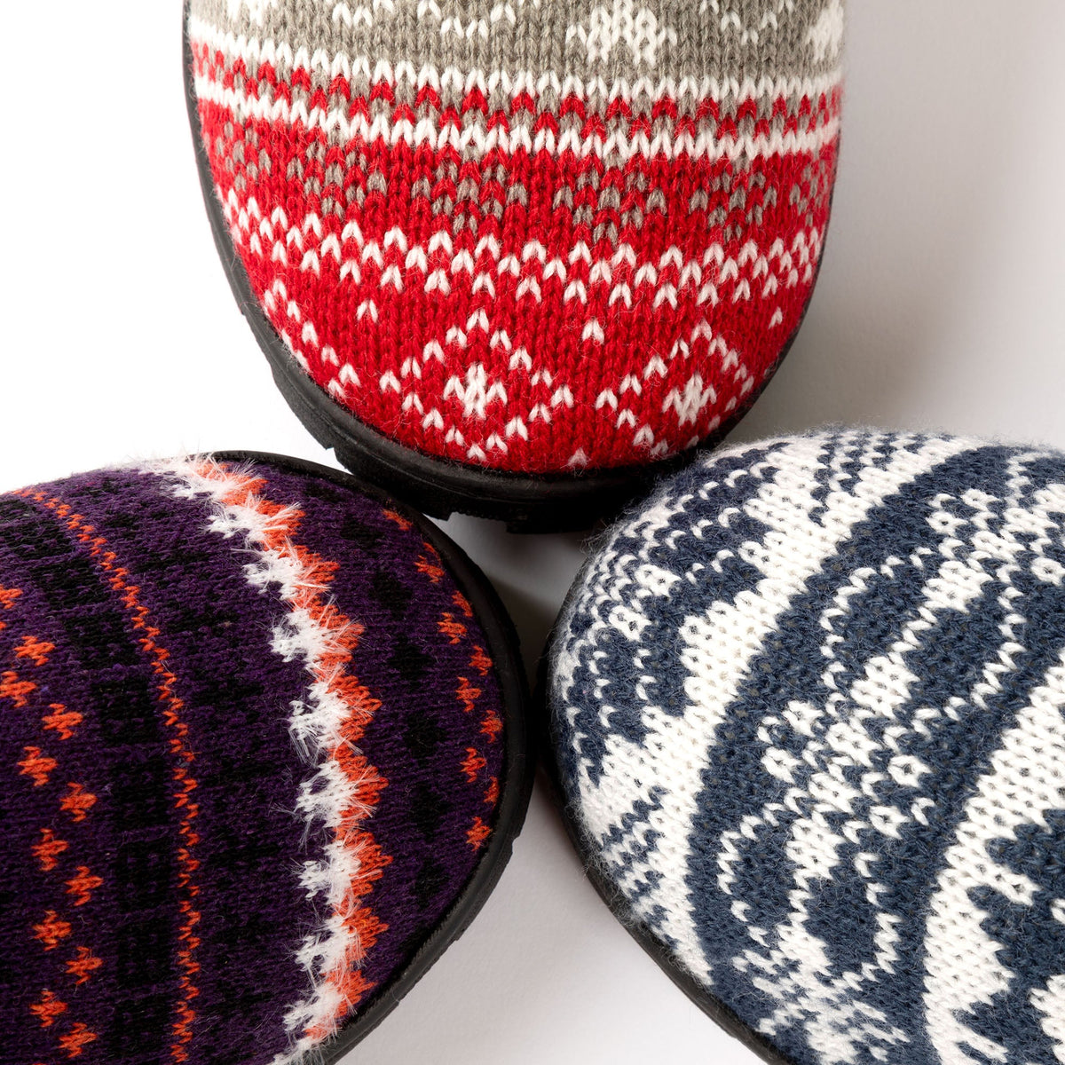Knit clog slippers with patterned knit uppers and treaded black rubber soles