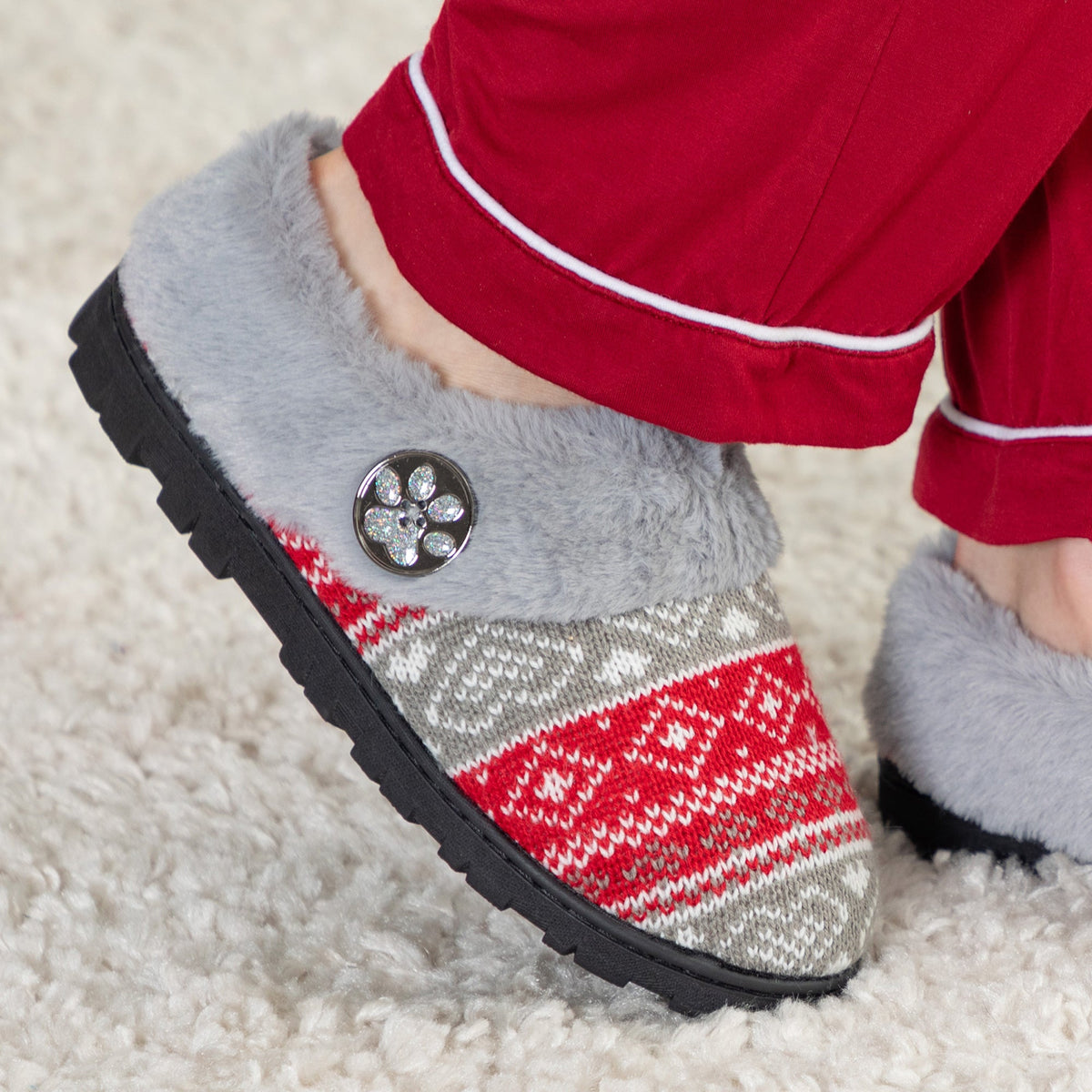 Gray faux-fur knit clog slippers with red-and-gray striped pattern and paw badge on vamp