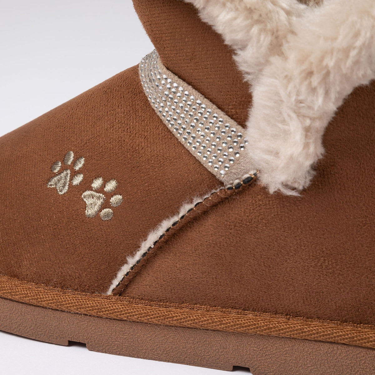 Tan faux suede ankle boot close-up: paw print, rhinestone strap, faux fur trim.