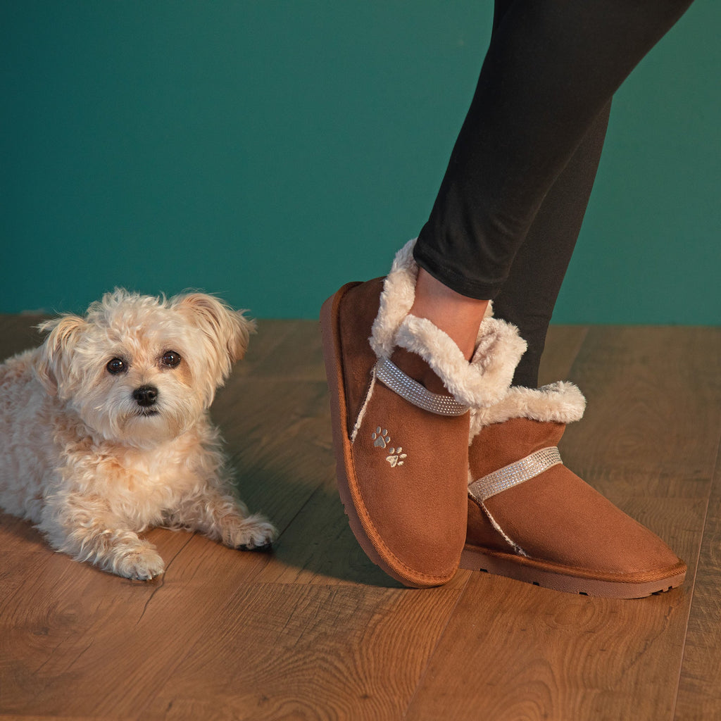 Tan ankle boots with faux fur trim, rhinestone strap, and paw-print detail.