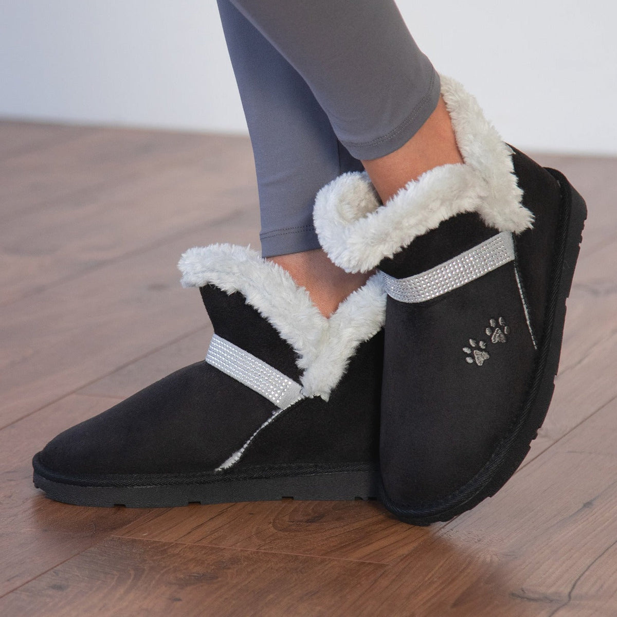 Black faux suede ankle boots with paw print, silver strap and white faux-fur collar