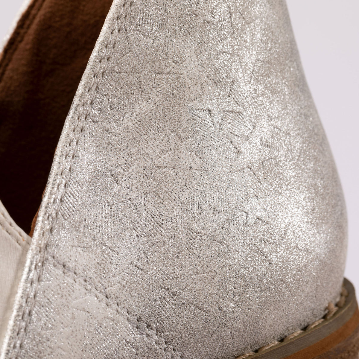White ankle boot upper with speckled textured finish and visible seam stitching