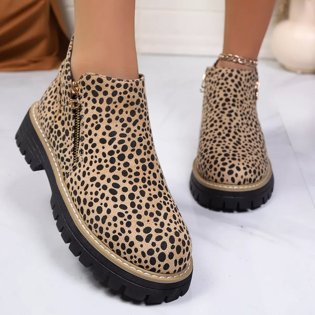 Leopard print ankle boots with side zipper and black lug sole, side view
