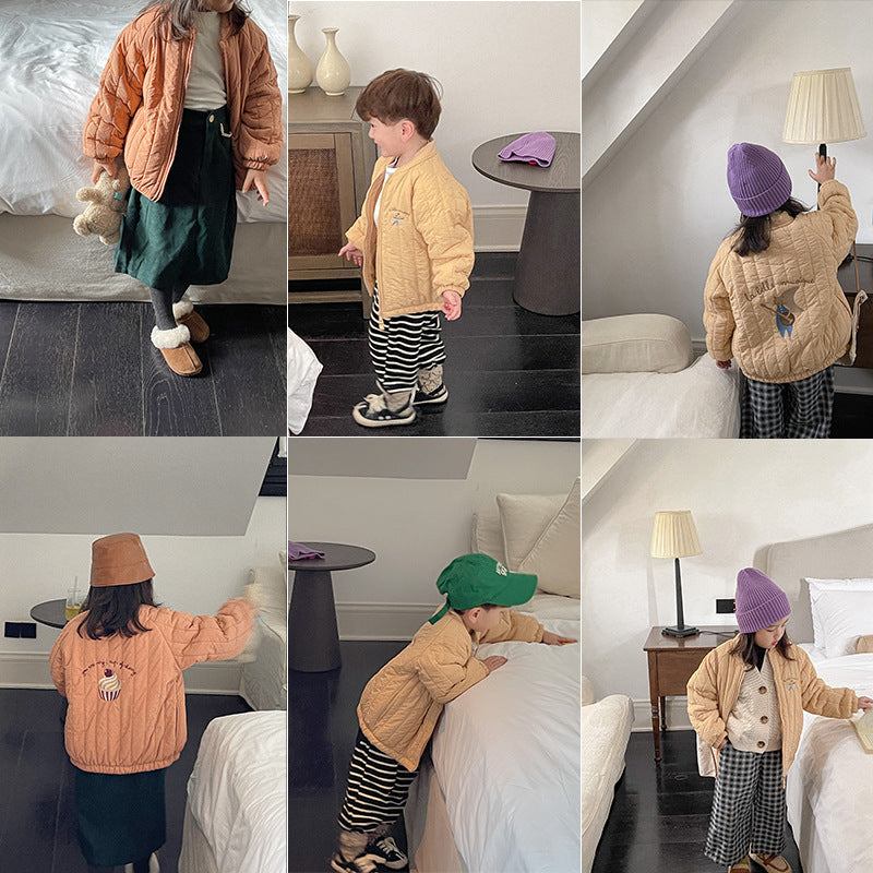 Child wearing plush cotton boys jacket with back graphic and quilted outer layer