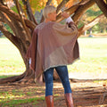 Khaki and red striped poncho worn as a wrap with flowing side drape