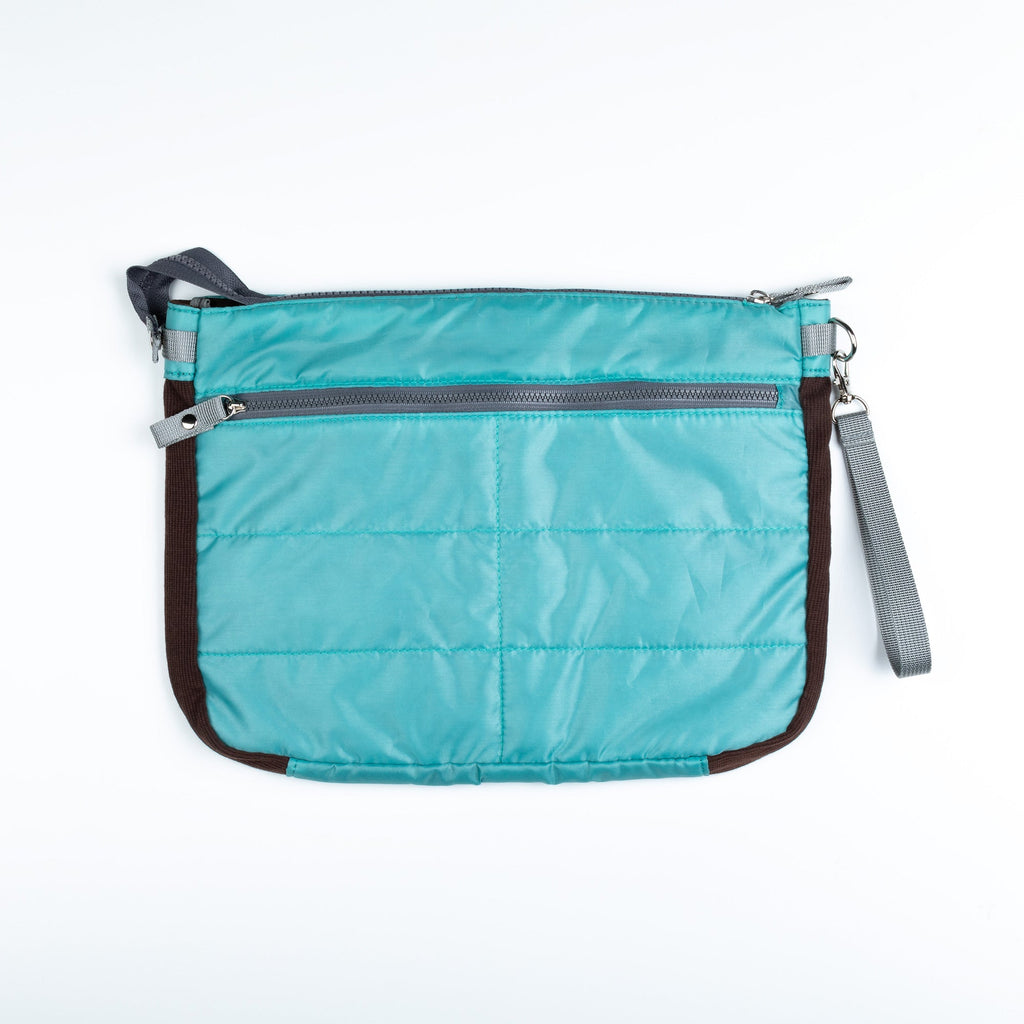 Blue puffer tablet carrying case with top zipper and side wrist strap