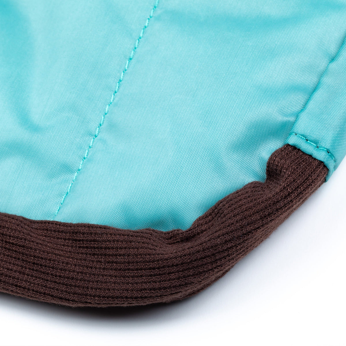 Blue puffer tablet case bottom edge with brown strap trim