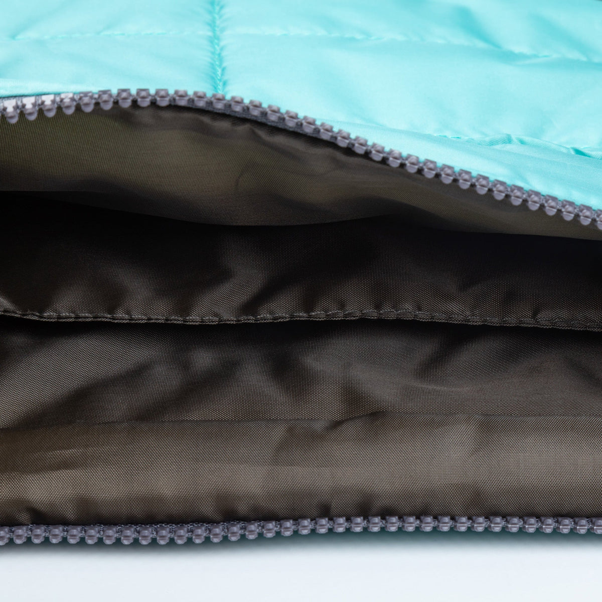 Blue puffer tablet case interior with gray lining and zipper track