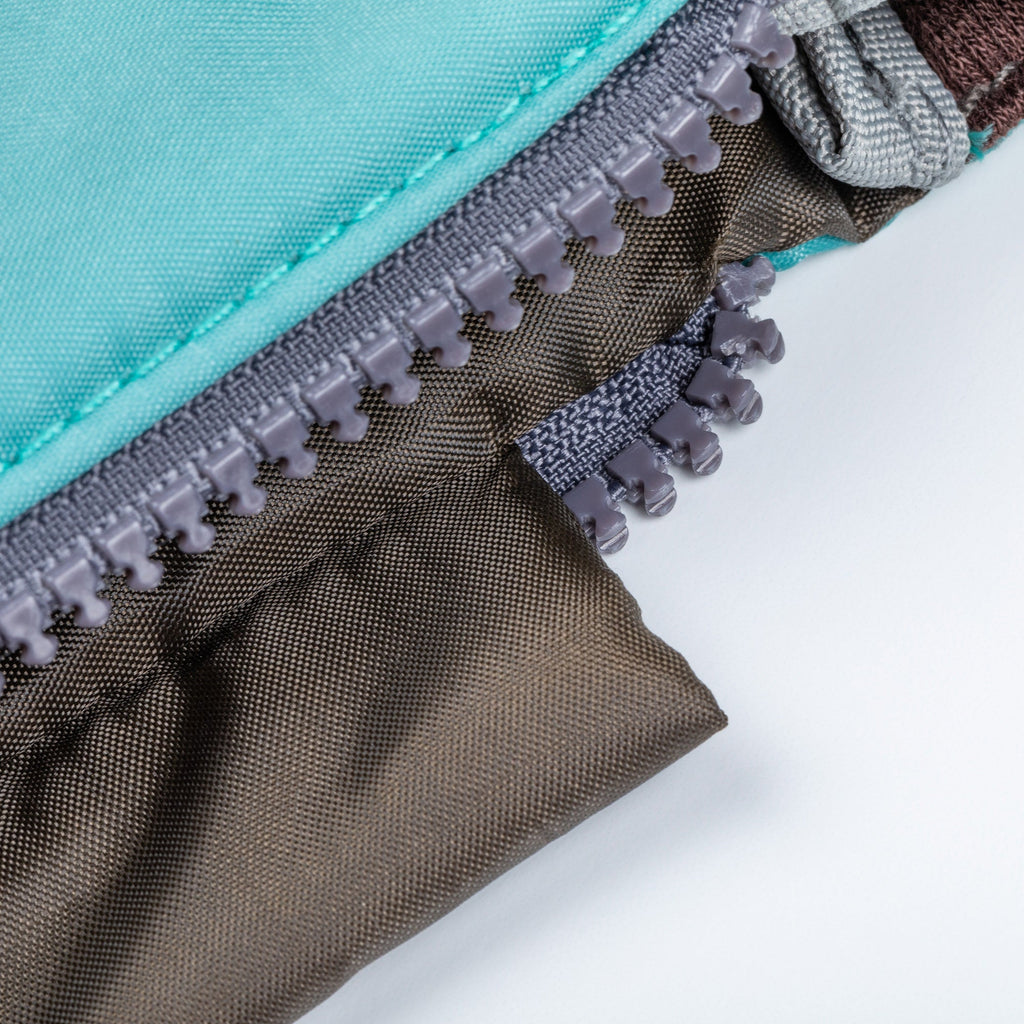 Blue puffer tablet case zipper close-up with grippy zipper pull