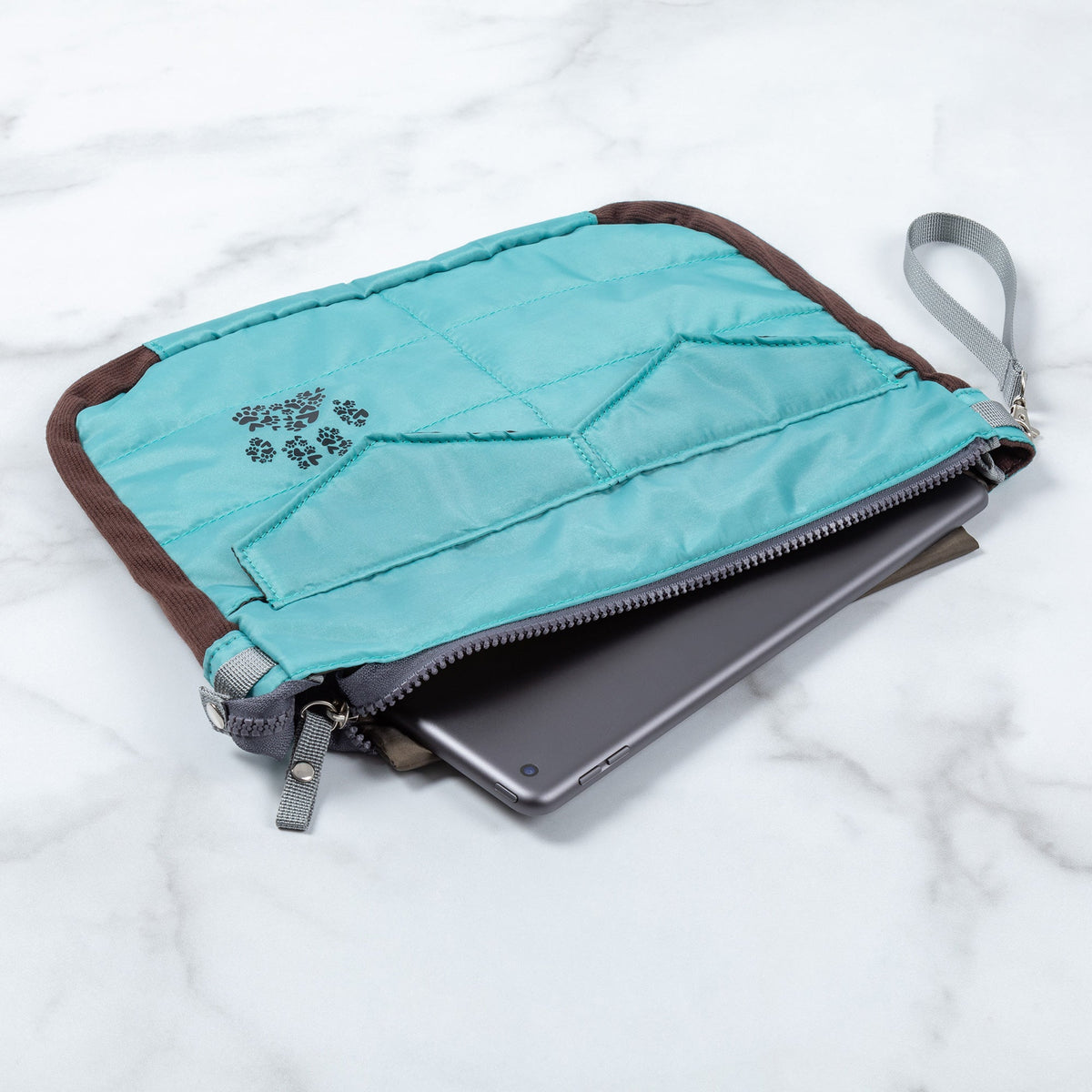 Blue puffer tablet carrying case with paw print patch and zip closure