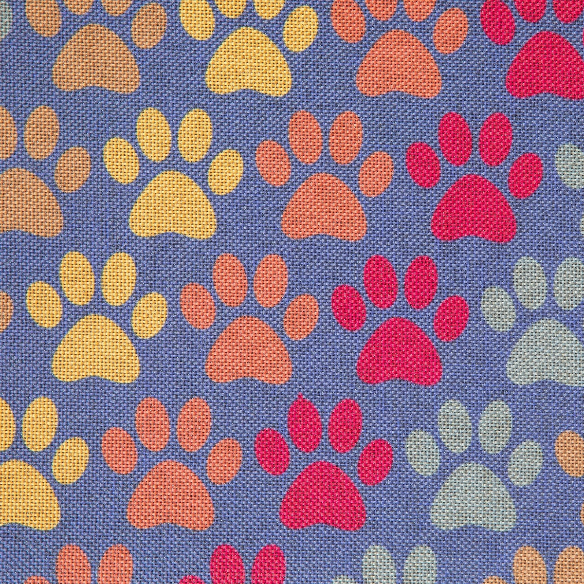 Close-up of blue fabric with multicolor paw prints in red, orange, yellow, and gray