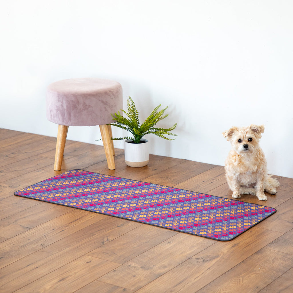 Rectangular floor runner with blue base and multicolor paw print pattern