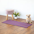 Rectangular floor runner with blue base and multicolor paw print pattern