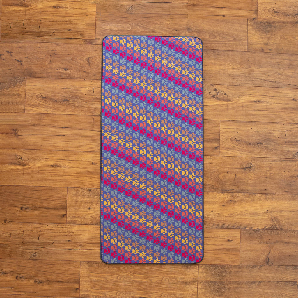 Pastel pet floor runner with multicolor paw prints on blue background and border