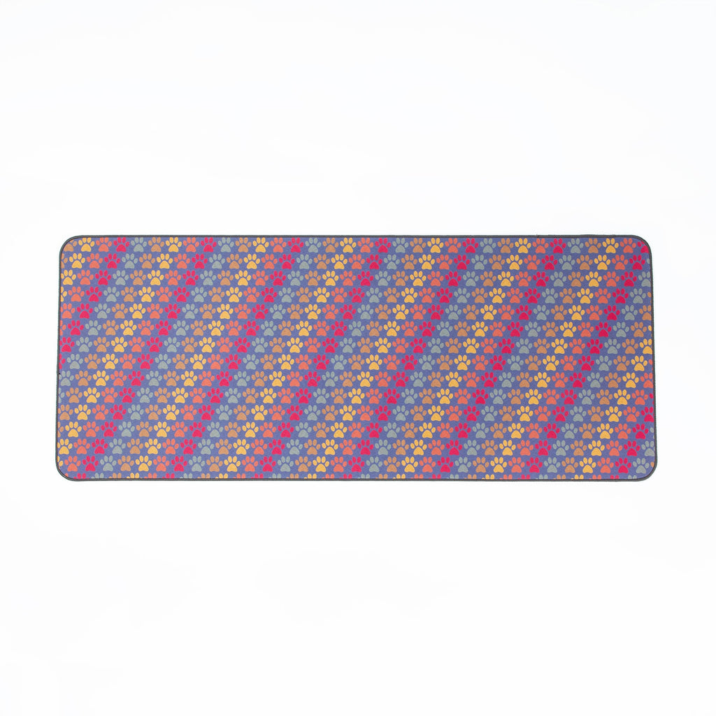 Rectangular floor runner with blue base and scattered multicolor paw print pattern
